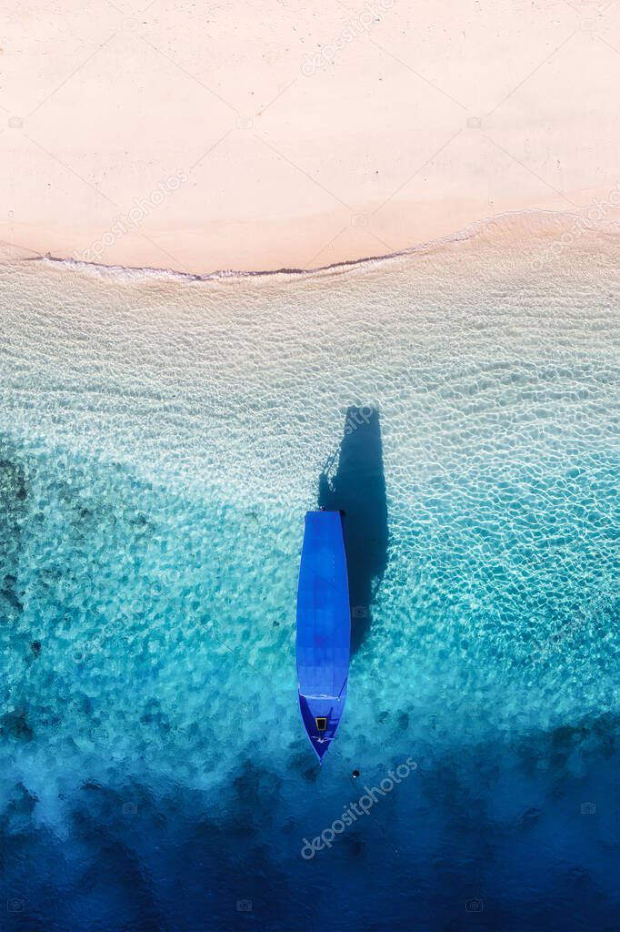 Boat near the beach. Seascape from drone. Blue water background from top view.. Gili Meno island, Indonesia. Travel - image