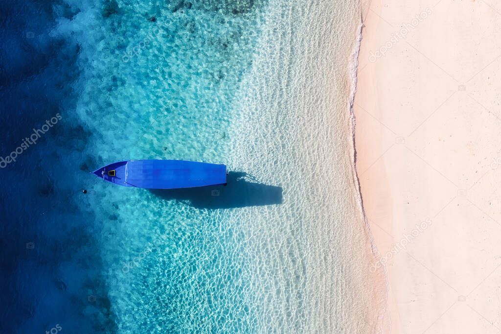 Boat on the beach. Seascape from drone. Blue water background from top view. Summer seascape from air. Gili Meno island, Indonesia. Travel - image