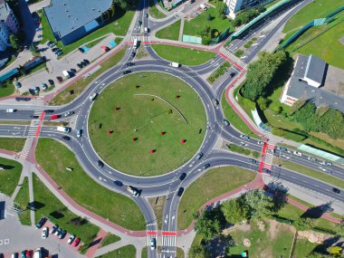 Roundabout intersection in five directions with island, aerial view. clipart
