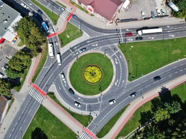 Roundabout intersection in three directions with island, aerial view. clipart