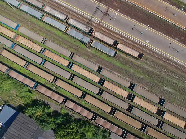 Aerial view on cargo wagons on train station in city.