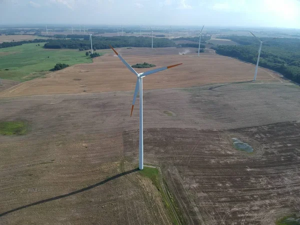 Aerial view on wind turbine tower on wheat field.