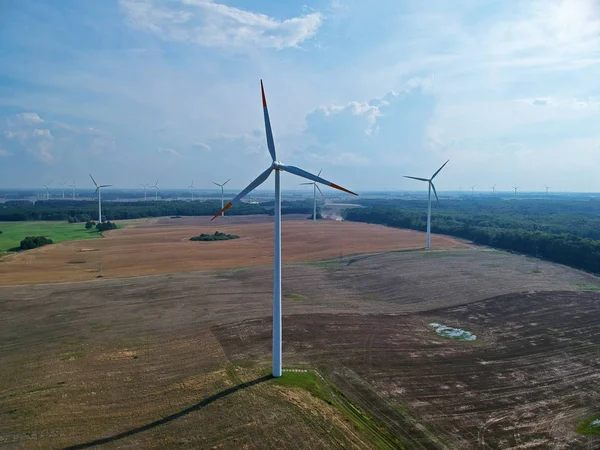 Aerial view on wind turbine tower on wheat field.