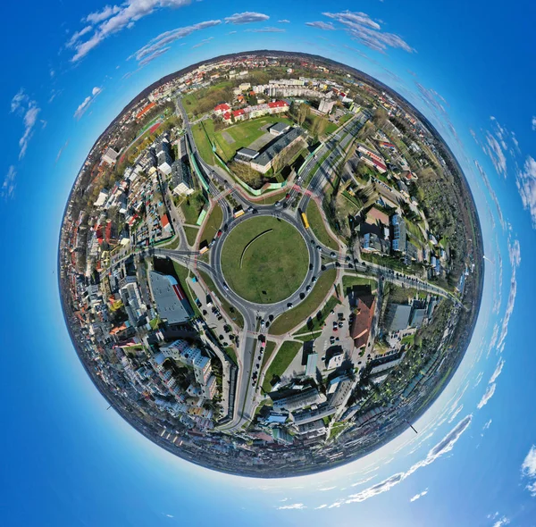 Aerial 360 angle panoramic little planet view on roundabout junction in medium city with traffic — Stock Photo, Image
