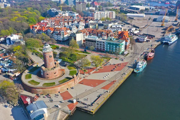 KOLOBRZEG, POLAND - 25 APRIL 2019 - Aerial view on Kolobrzeg city, area of Lighthouse at Baltic Sea shore and Ship Port with Monika Ship, Viking Ship. — Stock Photo, Image