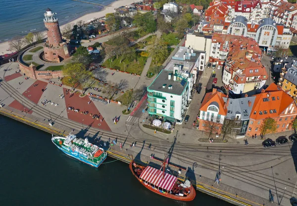 KOLOBRZEG, POLAND - 25 APRIL 2019 - Aerial view on Kolobrzeg city, area of Lighthouse at Baltic Sea shore and Ship Port with Monika Ship, Viking Ship. — Stock Photo, Image