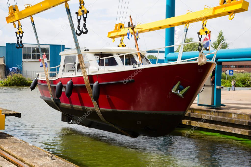 Boat crane lifting a motorboat