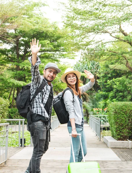 Young tourist are goodbye with their friend before travelling