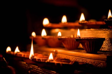 Diwali diya veya hediyeler, moody arka plan üzerinde çiçekler ile gece aydınlatma. Seçici odak