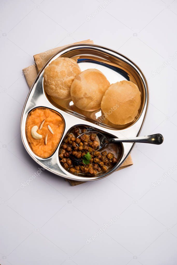 Suji/Sooji Halwa Puri or Shira Poori breakfast, served in a plate and bowl. selective focus
