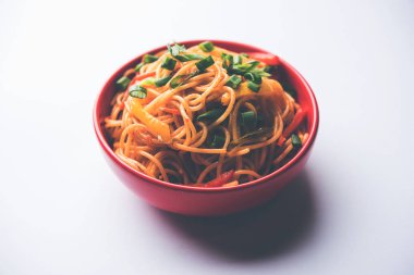 Schezwan erişte veya sebze Hakka erişte veya chow mein tahta çubukla bir kase veya plaka servis popüler Hint-Çin yemek tarifleri, var. seçici odak