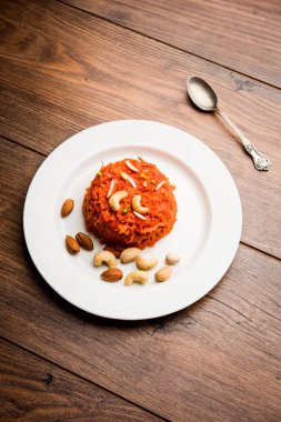 Gajar ka halwa Hindistan'dan şekerli tatlı havuç tabanlı pudingim. Kaju/badem fındık ile süslenmiş. bir kasede servis.