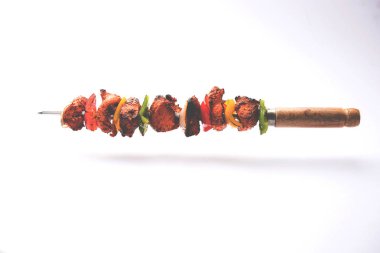 Tavuk tikka/Kebap çarpık. Geleneksel Hint yemeği kömür ve alev üzerinde pişmiş, terbiyeli ve rengarenk süslenmiş. yeşil Hint turşusu ve salata ile servis. seçici odak
