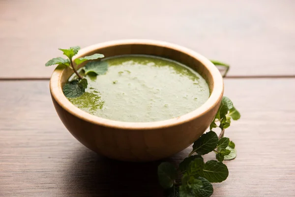 Healthy Green Mint Chutney Made with Coriander, pudina And Spices. isolated moody background. selective focus