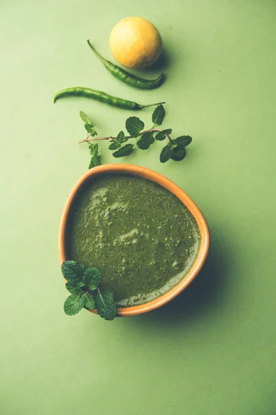 Healthy Green Mint Chutney Made with Coriander, pudina And Spices. isolated moody background. selective focus