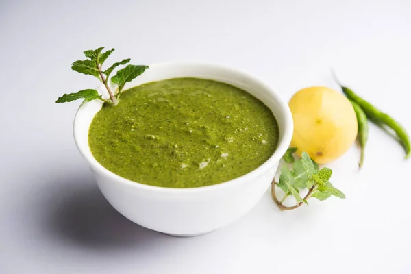 Healthy Green Mint Chutney Made with Coriander, pudina And Spices. isolated moody background. selective focus