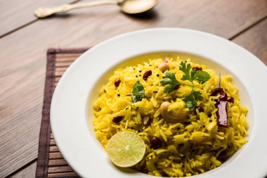 Limon pirinç kalan pirinç süslenmiş fındık köri yaprakları ve limon suyu, seçici odak kullanarak fodnicha bhat denilen bir Güney Hint zerdeçal pirinç veya maharashtrian reçetedir