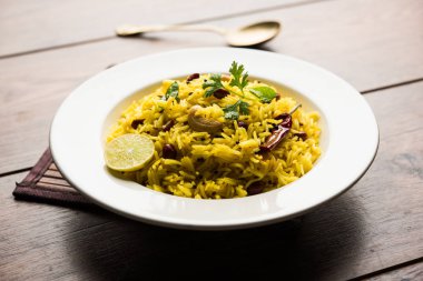 Limon pirinç kalan pirinç süslenmiş fındık köri yaprakları ve limon suyu, seçici odak kullanarak fodnicha bhat denilen bir Güney Hint zerdeçal pirinç veya maharashtrian reçetedir