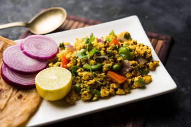 Paneer Bhurji, hafif pütürlü kapış baharatlı ve roti veya laccha paratha, seçici odak ile hizmet