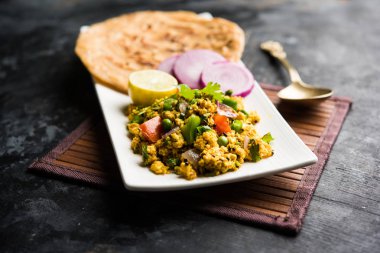 Paneer Bhurji, hafif pütürlü kapış baharatlı ve roti veya laccha paratha, seçici odak ile hizmet