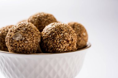 Tilgul Laddu veya Til Gul topu için makar sankranti, susam, ezilmiş fıstık ve jaggery kullanılarak yapılan bir sağlıklı besindir. bir kasede servis. seçici odak gösteren Ayrıntılar.