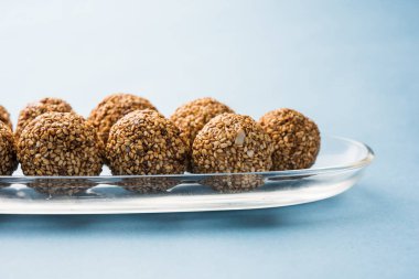 Tilgul Laddu veya Til Gul topu için makar sankranti, susam, ezilmiş fıstık ve jaggery kullanılarak yapılan bir sağlıklı besindir. bir kasede servis. seçici odak gösteren Ayrıntılar.