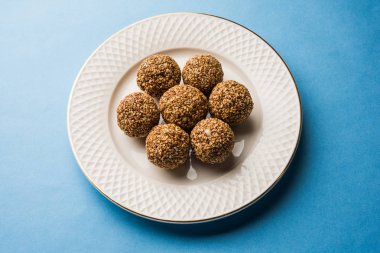 Tilgul Laddu veya Til Gul topu için makar sankranti, susam, ezilmiş fıstık ve jaggery kullanılarak yapılan bir sağlıklı besindir. bir kasede servis. seçici odak gösteren Ayrıntılar.