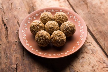 Tilgul Laddu veya Til Gul topu için makar sankranti, susam, ezilmiş fıstık ve jaggery kullanılarak yapılan bir sağlıklı besindir. bir kasede servis. seçici odak gösteren Ayrıntılar.