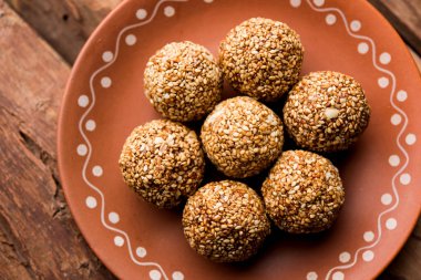 Tilgul Laddu veya Til Gul topu için makar sankranti, susam, ezilmiş fıstık ve jaggery kullanılarak yapılan bir sağlıklı besindir. bir kasede servis. seçici odak gösteren Ayrıntılar.