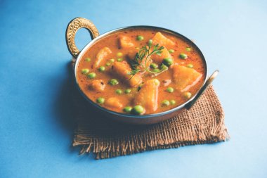 Hint Aloo Mutter köri - patates ve bezelye bir soğan domates et suyu dalmış ve kişniş yaprakları ile süslenmiş. Bir Karahi/kadhai veya pan veya kase servis. seçici odak