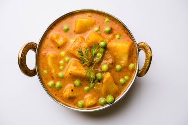 Hint Aloo Mutter köri - patates ve bezelye bir soğan domates et suyu dalmış ve kişniş yaprakları ile süslenmiş. Bir Karahi/kadhai veya pan veya kase servis. seçici odak