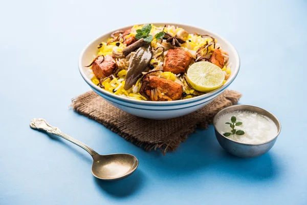 Hint tavuk Tikka Biriyani bir kase yoğurt ile servis. seçici odak