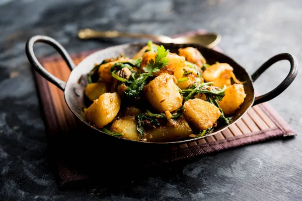 Stock image Aloo Palak sabzi - Potato cooked with spinach with added spices. a healthy Indian main course recipe. Served in a bowl, selective focus