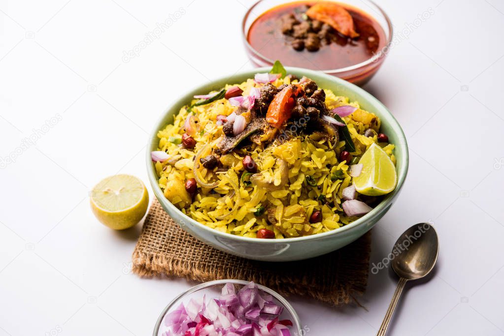 Aloo/Kanda Poha or Tarri Pohe with spicy chana masala/curry. selective focus