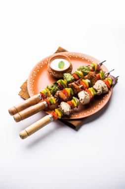 Hariyali kakab tavuk mu ile hizmet Malai Kebap şişleri ve yoğurt dip bir tabak içinde. seçici odak