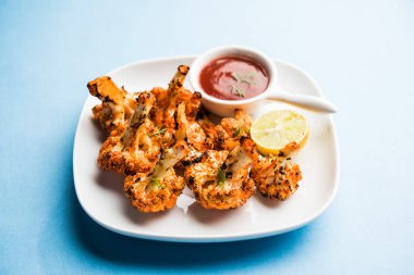 Tandır Gobi / kavrulmuş karnabahar Tikka Hindistan'dan bir marş besindir. Ketçap ile servis. seçici odak