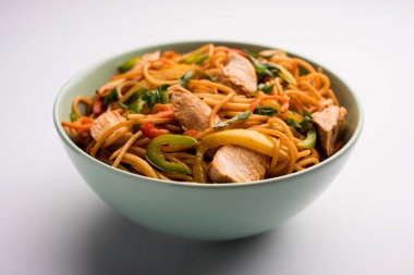 Tavuk Hakka / Schezwan erişte yemek çubukları ile bir kase içinde servis edilir. seçici odaklama