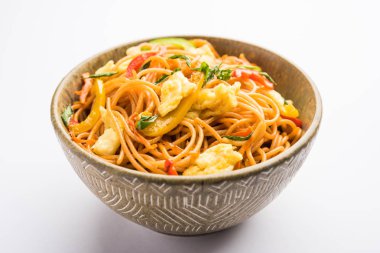 Egg Schezwan/hakka noodles, popular indochinese food served in a bowl with chopsticks. selective focus clipart