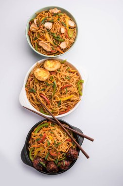 Manchurian Hakka / Schezwan noodles with chicken and egg, popular indochinese food served in a bowl. selective focus clipart