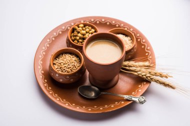 Sattu sharbat is a cooling sweet drink made in summer with roasted black chickpea flour, barley, suger, salt & water. served in a glass. selective focus clipart
