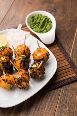Tandır aloo Hint baharatları ile kavrulmuş patates vardır. Yeşil chutney ile servis edilen bir parti mezesi. seçici odaklama