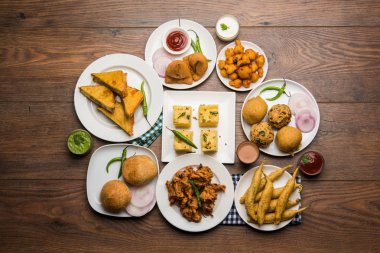 Grup Hint Çay saati aperatifler Veg Samosa, Kachori / kachaudi, aloo bonda, khaman dhokla, ekmek, soğan, biber ve moong pakora / pakoda / bhaji / bhajji / Bhajiya / soslar, seçici odak ile bajji içerir