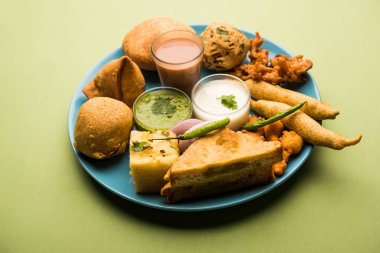 Grup Hint Çay saati aperatifler Veg Samosa, Kachori / kachaudi, aloo bonda, khaman dhokla, ekmek, soğan, biber ve moong pakora / pakoda / bhaji / bhajji / Bhajiya / soslar, seçici odak ile bajji içerir