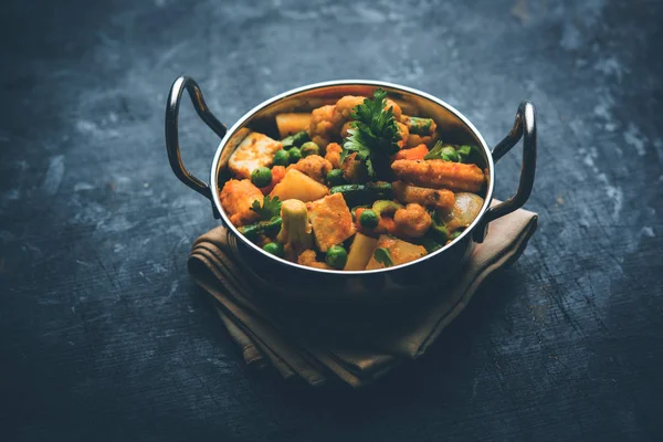 Mix vegetable curry - Indian main course recipe contains Carrots, cauliflower, green peas and beans, baby corn, capsicum and paneer/cottage cheese with traditional masala and curry, selective focus