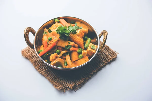 Mix vegetable curry - Indian main course recipe contains Carrots, cauliflower, green peas and beans, baby corn, capsicum and paneer/cottage cheese with traditional masala and curry, selective focus