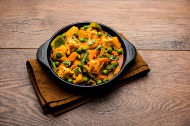 Mix sebze köri - Hint ana yemek tarifi havuç, karnabahar, yeşil bezelye ve fasulye, bebek mısır, kırmızı biber ve paneer / yazlık peynir geleneksel masala ve köri, seçici odak içerir