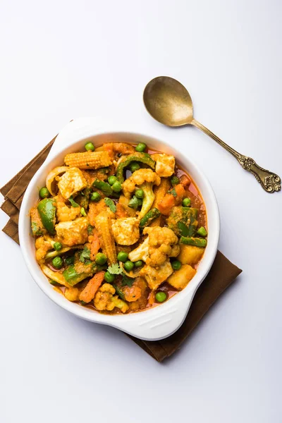 Mix vegetable curry - Indian main course recipe contains Carrots, cauliflower, green peas and beans, baby corn, capsicum and paneer/cottage cheese with traditional masala and curry, selective focus