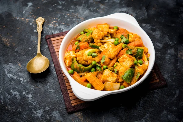 Mix vegetable curry - Indian main course recipe contains Carrots, cauliflower, green peas and beans, baby corn, capsicum and paneer/cottage cheese with traditional masala and curry, selective focus