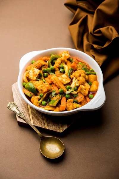 Mix vegetable curry - Indian main course recipe contains Carrots, cauliflower, green peas and beans, baby corn, capsicum and paneer/cottage cheese with traditional masala and curry, selective focus