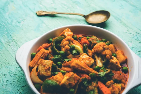 Mix vegetable curry - Indian main course recipe contains Carrots, cauliflower, green peas and beans, baby corn, capsicum and paneer/cottage cheese with traditional masala and curry, selective focus